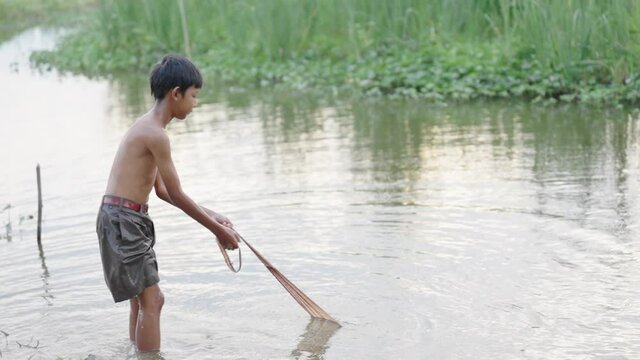 boy fishing in liver at summer