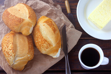 Brazilian French bread, on rustic paper, on rustic wooden table for breakfast