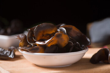wet black fungus on wood background