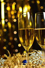 Glasses of champagne on golden background. new year and christmas celebration