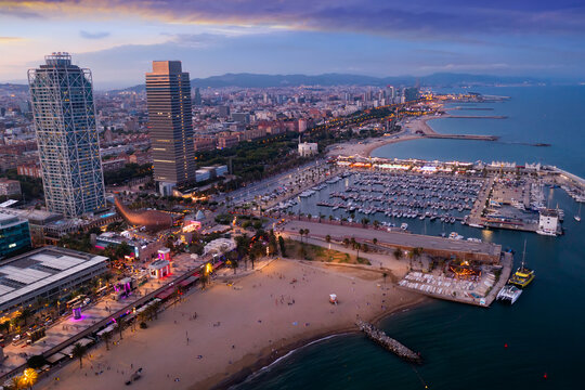 Picturesque evening aerial view of coastal area of Barcelona overlooking Olympic Harbor marina with moored pleasure yachts and modern architecture of waterfront in summer, Spain.. © JackF