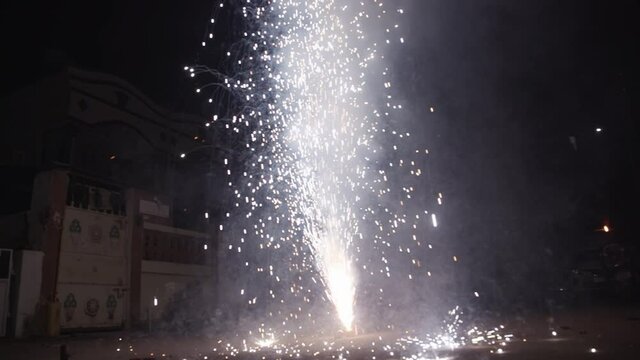 Slow motion shot of a cracker known as flower pot bursting on Diwali celebrations in India