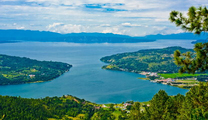 Naklejka na ściany i meble The beauty of Lake Toba which is a caldera lake comes from an ancient volcanic eruption and is the largest volcanic lake in the world. View from geosite hutaginjang. North Sumatra, Indonesia