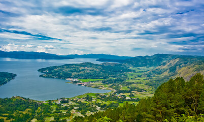 Naklejka na ściany i meble The beauty of Lake Toba which is a caldera lake comes from an ancient volcanic eruption and is the largest volcanic lake in the world. View from geosite hutaginjang. North Sumatra, Indonesia