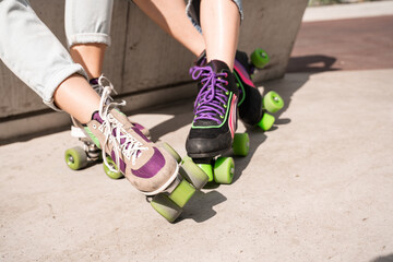 cropped view of female legs in roller skates outdoors.