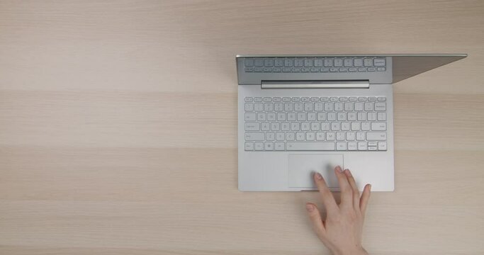 Flat lay. Copy space. Office desk top view. Bright workplace with girl's hands, laptop.