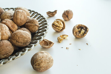 Walnut in plate on white background.