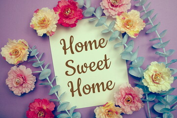 Home Sweet Home typography text and flower decorate on purple background