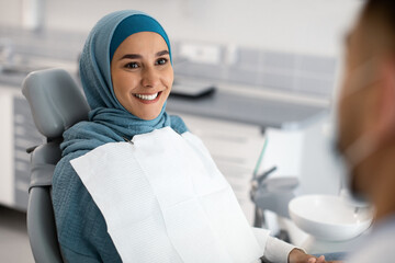 Smiling Muslim Lady In Hijab Having Check Up In Modern Dental Clinic