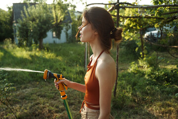 woman watering plants in the garden countryside nature cultivation