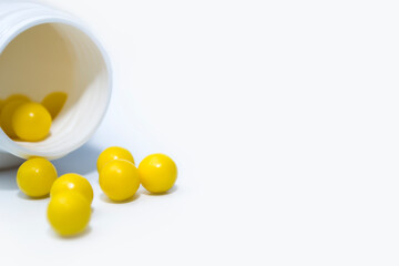Bottle with tablets in the form of capsules on a white background