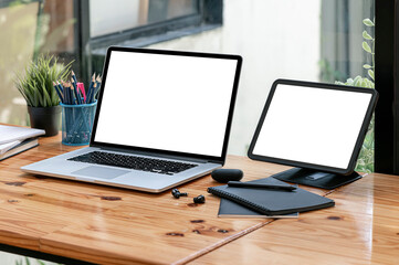 Mockup blank white screen laptop and portable tablet.