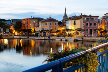Scenic view of Provencale Venice, French town of Martigues on Mediterranean coast overlooking buildings on bank of canal at dusk in early autumn