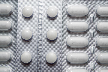 White medicine pills in blister pack. The concept of medicine or drug abuse