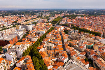 Fototapeta na wymiar Bird's eye view of Perpignan, France. Red rooftops of residential buildings visible from above.