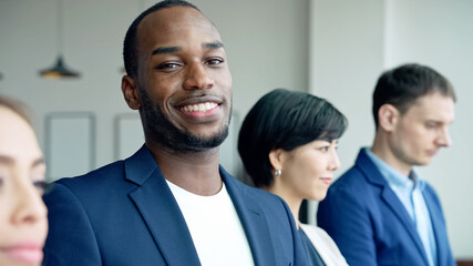 African businessman smiling in the office. Global business.