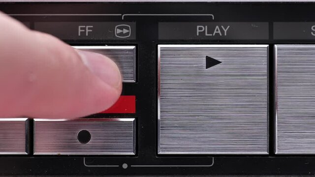 Extreme close up of buttons on an old antique or vintage VCR Pushing the Fast forward button