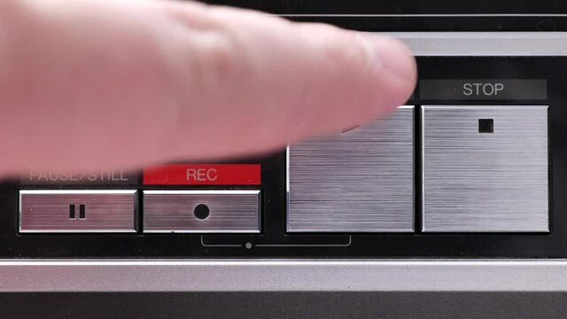 Extreme close up of buttons on an old antique or vintage VCR Pushing the play button a bunch of times or aggressively