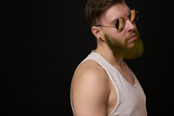 bearded man in white t-shirt with tattoos on his arms posing bully