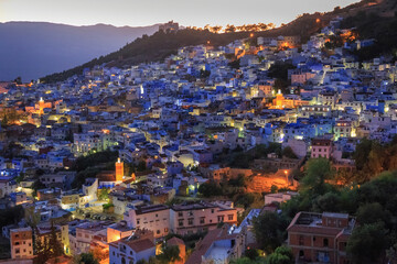 Fototapeta na wymiar Aerial evening view of Chefchaouen in Morocco. The city is noted for its buildings in shades of blue and that makes Chefchaouen very attractive to visitors.