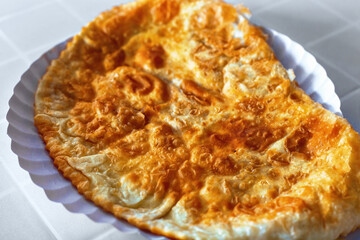 Chebureki (deep-fried turnover with a filling of ground or meat and onions). It is made with a single round piece of dough folded in a crescent shape. Is a national dish of Crimean Tatar cuisine.