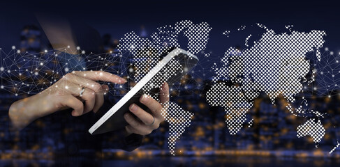 Global network against a dark background. Hand touch white tablet with digital hologram world,...