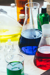 Beaker and and other laboratory items with green and blue chemical reagent. Chemical experiment with Laboratory glass