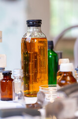 Glass flask with orange liquid on laboratory table