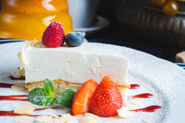 Piece of classic cheesecake with strawberries on a plate