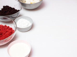 The ingredients for creating a trifle are placed in bowls on a white table. A place to write recipes. Selective focus.