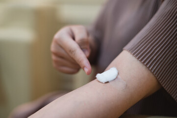 pregnant woman draws blood from an injection wound on a patient's arm.