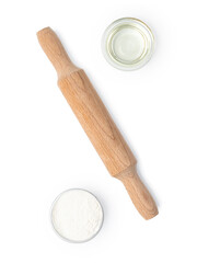 Baking ingredients and rolling pin on white background