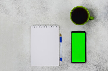 notepad with pen, template and blank paper with copy space text, business mock up, background for plans, goals and resolution and a cup of coffee on the table