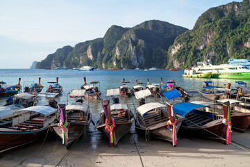 Beautiful landscape with traditional longtail boats, rocks, cliffs, tropical beach. Phi Phi Don...