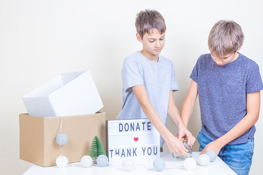 Christmas Donation To Animal Shelter. Volunteer Teenagers Collecting Donations, Preparing Animal Donation Box For Animal Shelters At Christmas Charity