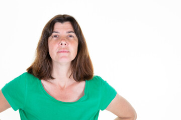 middle aged woman looking at camera posing against white background