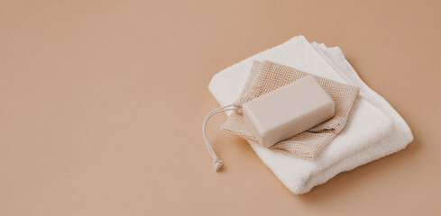 A bar of natural handmade soap lies on a soft white towel. Health beauty natural products concept. Organic natural cosmetics
