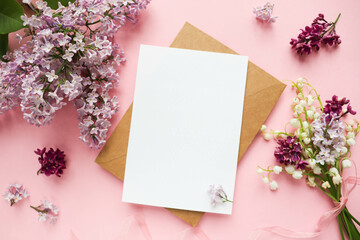 spring greeting card. frame made of lilac branches and white blank for text 