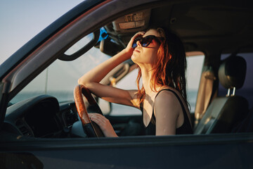 Obraz na płótnie Canvas woman driving in car trip posing fashion travel