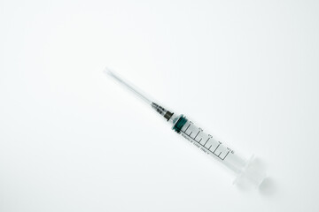 Medical syringe and needle on a light background