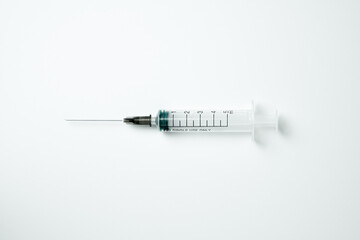 Medical syringe and needle on a light background
