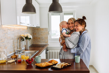 Affectionate women enjoying in time with a baby son at home