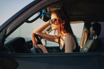 Fototapeta na wymiar woman driving in car trip posing fashion travel