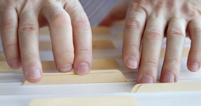 Male hands are going through large pile of documents slow motion 4k movie