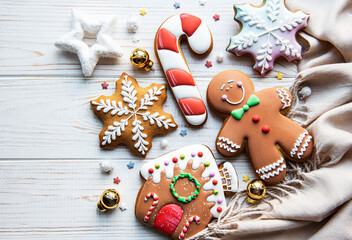 Christmas gingerbread with christmas decorations on white wooden table