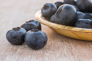 Blueberries in a bowl on a wooden table.