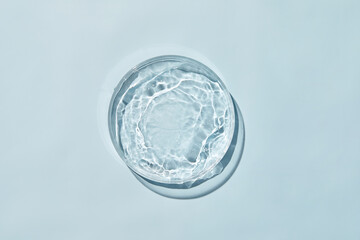 Petri dish with water and ripple in blue background - obrazy, fototapety, plakaty
