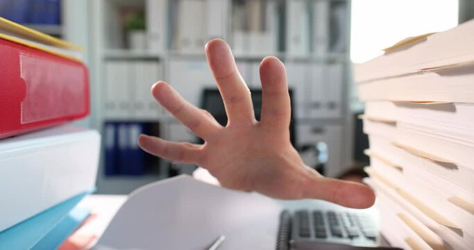 Man hand reaches along documents and folders on desktop slow motion 4k movie