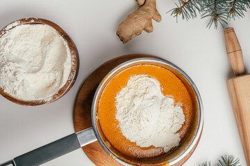 Step-by-step tutorial on baking Christmas gingerbread cookies. Step 8: Add flour little by little, top view