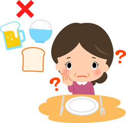 食卓で考え込む中年女性と糖質制限のイメージ